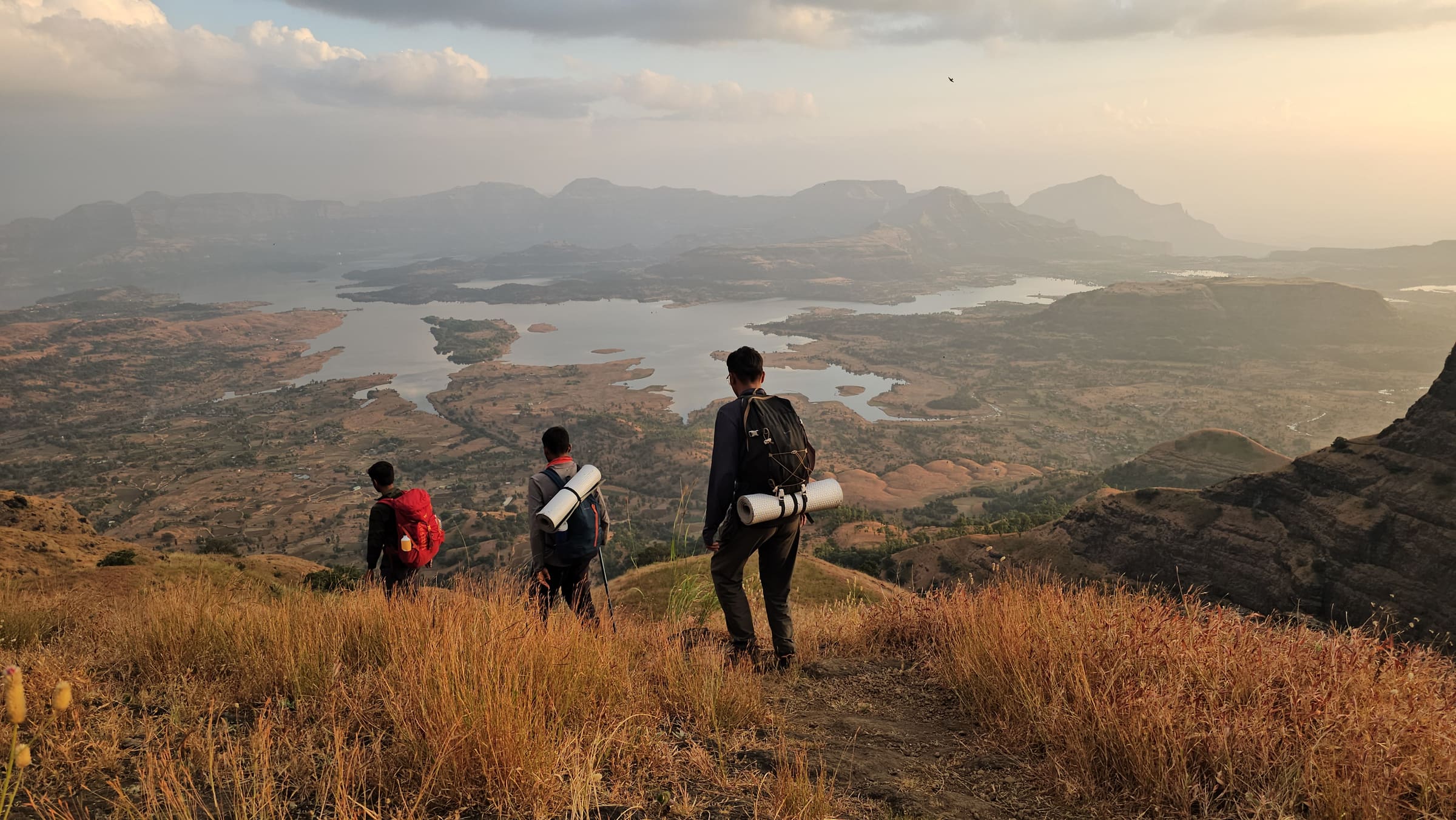 Descend towards Udadavne with Bhandardhara reservoir in view